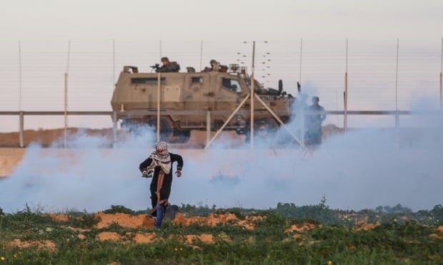 متظاهرة فلسطينية ومن خلفها قوات الاحتلال عند السياج الحدودي لغزة خلال تظاهرات مسيرة العودة الكبرى (الأناضول) متظاهرة فلسطينية ومن خلفها قوات الاحتلال عند السياج الحدودي لغزة خلال تظاهرات مسيرة العودة الكبرى (الأناضول)