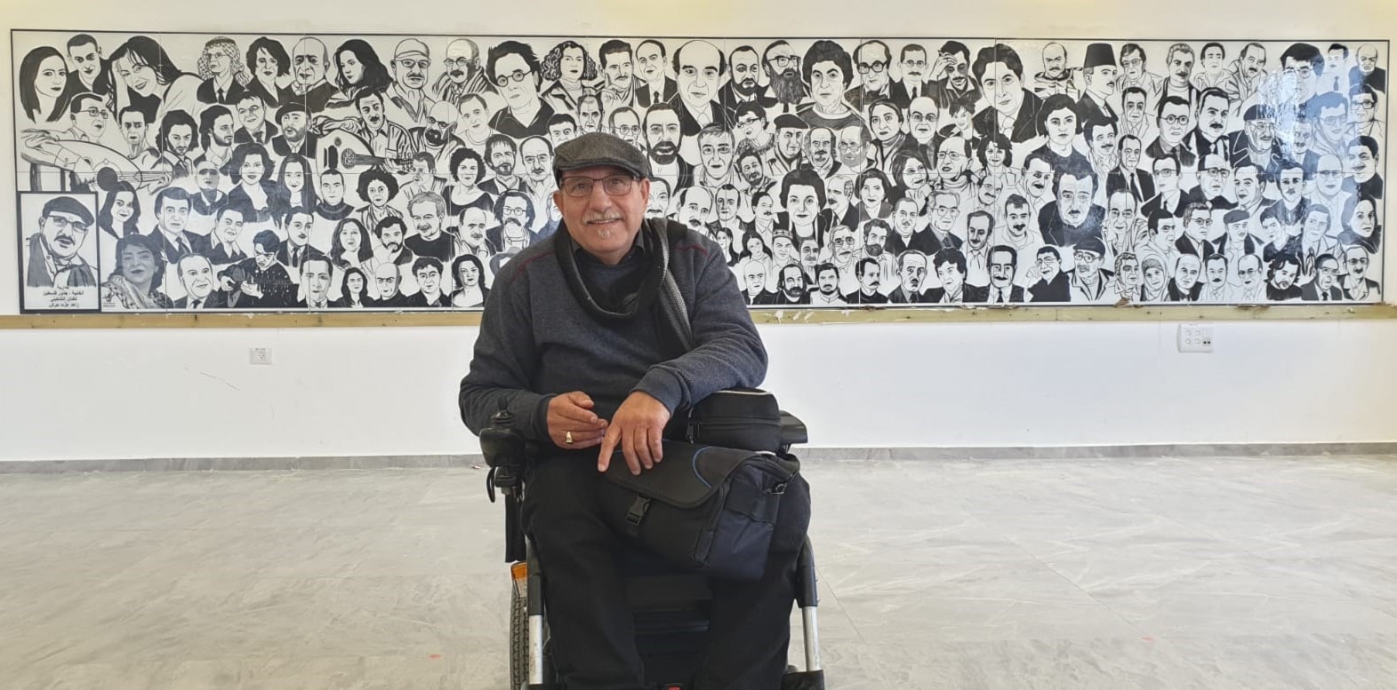 الفنان زاهد عزت حرش أمام جدارية الخابية الفلسطينية من تصميمه الفنان زاهد عزت حرش أمام جدارية الخابية الفلسطينية من تصميمه
