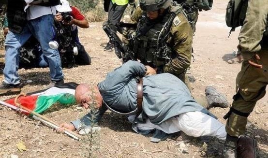الناشط الفلسطيني المسنّ خيري حنون مكبلاً أثناء الاعتداء عليه من قبل الاحتلال مطلع الشهر الناشط الفلسطيني المسنّ خيري حنون مكبلاً أثناء الاعتداء عليه من قبل الاحتلال مطلع الشهر