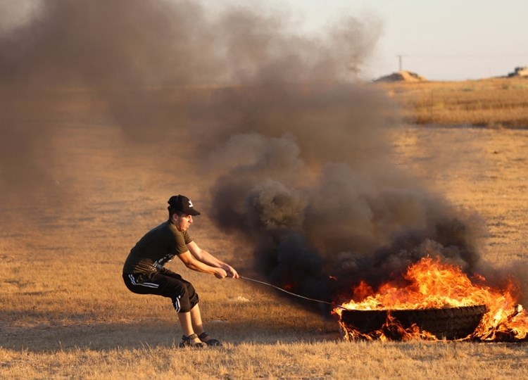 The Israeli occupation shoots at a group of young men in southern Gaza.