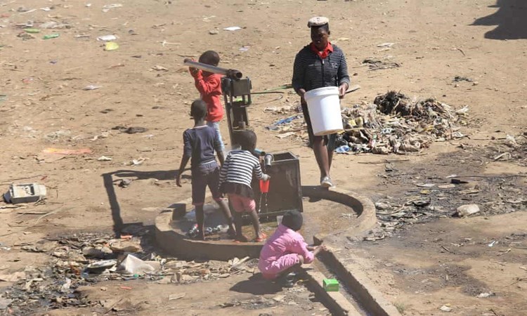 Children play in a water well near the Zimbabwean capital, Harare.