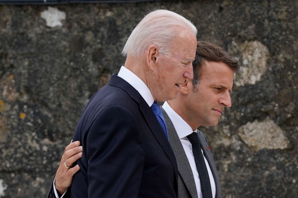 President Joe Biden speaks with French President Emmanuel Macron during the G7