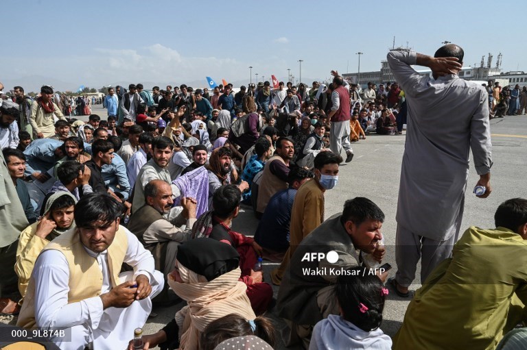 Afghan passengers wait to leave Kabul airport on August 16 (AFP).