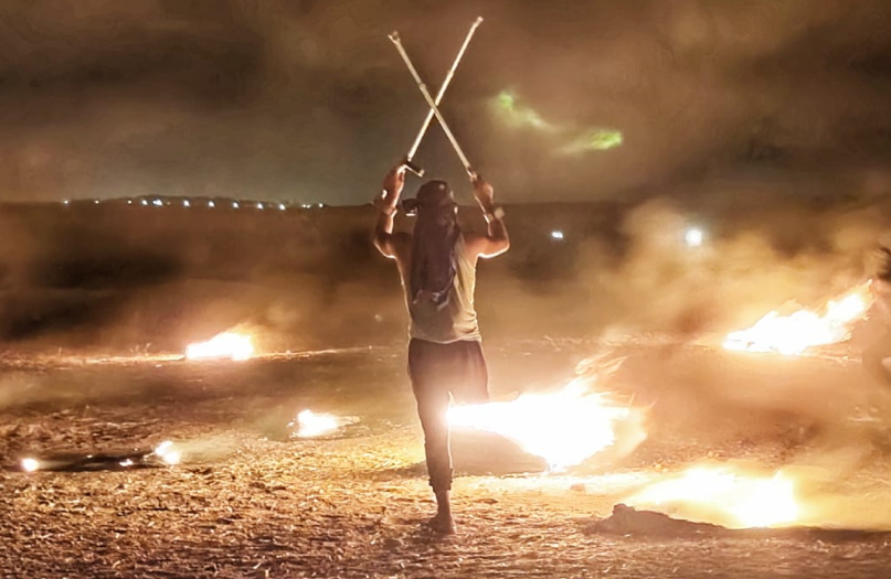 A Palestinian participating in the night confusion activities in Eastern Gaza