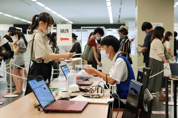 Japanese Citizens in a vaccine registration center in Tokyo